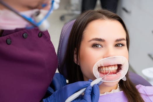 Happy woman getting dental check up in dentists office.