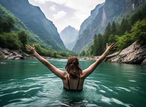 girl raising her arms contemplating the lake and the mountains, Europe. High quality photo
