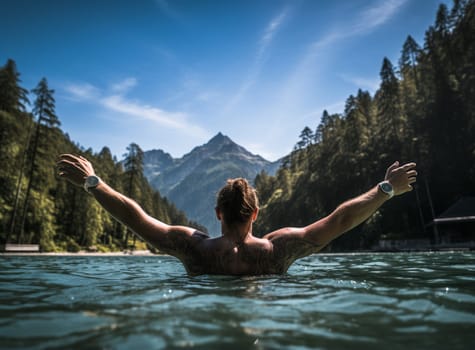 Man swimming in a beautiful mountain lake in the middle of the nature in the Alps. European famous destination. High quality photo