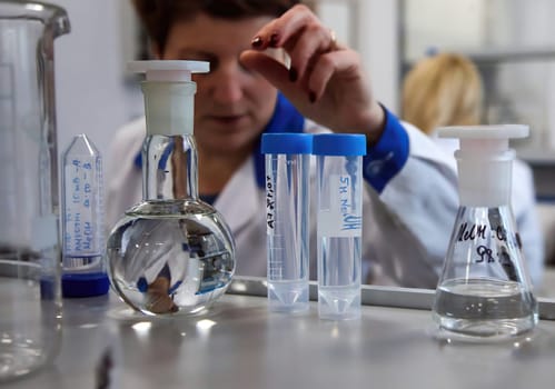 The doctor takes a test tube with liquid, close-up. Work in a chemical laboratory. Laboratory analysis