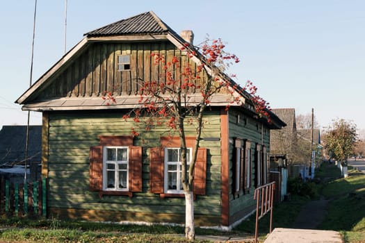 Charming wooden house with vintage window, rustic architecture, and countryside allure. Nostalgic symbol of simpler life, surrounded by natures beauty. Perfect for rustic charm and serene landscapes.