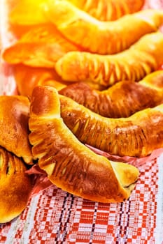 Assorted freshly baked bread and rolls on a white table. Golden brown, crusty bread and soft, fluffy rolls in various shapes and sizes. Perfect for breakfast, lunch, or dinner.