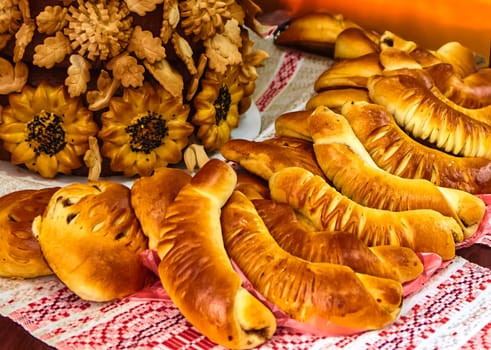 Assorted freshly baked bread and rolls on a white table. Golden brown, crusty bread and soft, fluffy rolls in various shapes and sizes. Perfect for breakfast, lunch, or dinner.