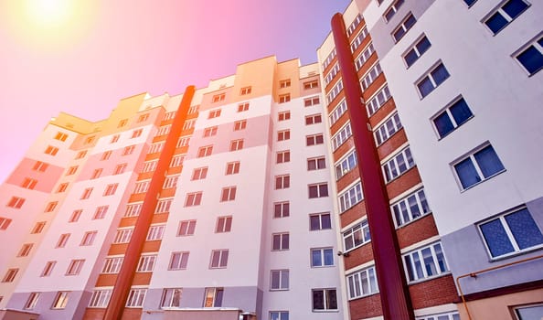 Contemporary apartment building with sleek facade, geometric windows, and balconies. Offers comfortable living spaces in urban setting with convenient access to city amenities.