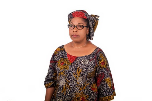 african mature woman in loincloth standing on white background.