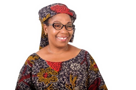 african mature woman in loincloth standing on white background looking at camera smiling.