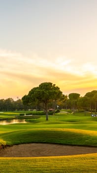 Panorama of the most beautiful sunset or sunrise. Sand bunker on a golf course without people with