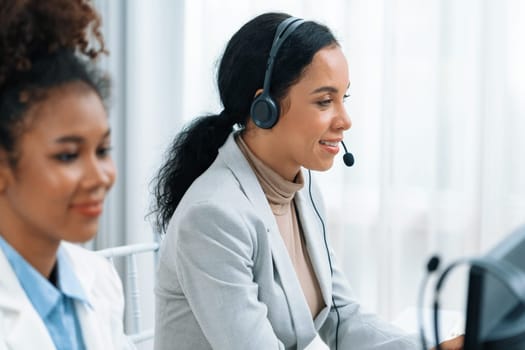 Business people wearing headset working in office to support remote customer or colleague. Call center, telemarketing, customer support agent provide service on telephone video conference call crucial
