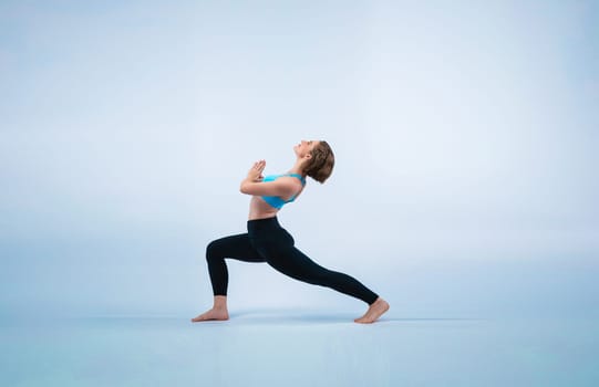 Full body length gaiety shot athletic and sporty woman doing healthy and meditative yoga exercise workout posture on isolated background. Healthy active and body care lifestyle