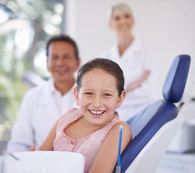 Portrait, dentist and man with kid in clinic for expert advice, confidence and orthodontics in medical health. Dental medicine, healthcare and professional with girl patient, smile and oral service.