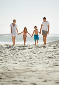 Parents, children and beach on vacation in summer with holding hands and smile for happiness in Florida. Family, adventure and travel for holiday with kids to relax, fun and enjoy trip in seaside