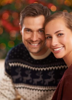 Portrait, Christmas and couple with holiday, romance and party with celebration and home with lights. Face, apartment and man with woman or peace with holiday and festive season with marriage or Xmas.