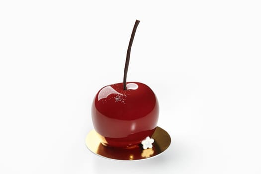 Stunning glossy red dessert in shape of cherry with chocolate stem, resting on gold serving cardboard, isolated on white background