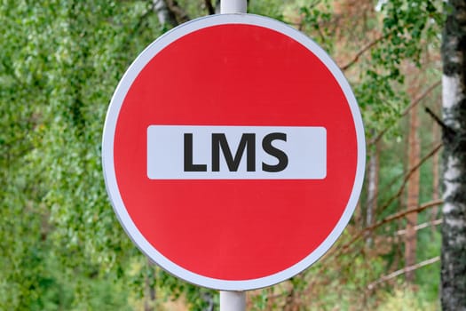Abbreviation of Learning management system, Word LMS writing on the sign entry is prohibited against the background of the forest