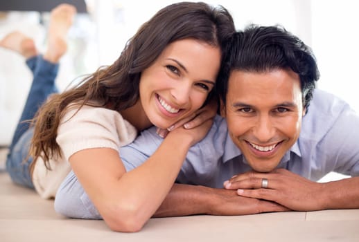 Portrait, couple and smile for rest and relaxation, romance and bonding together at home after work. Happy, husband and wife with hug, touch and love for positive, relationship and commitment.