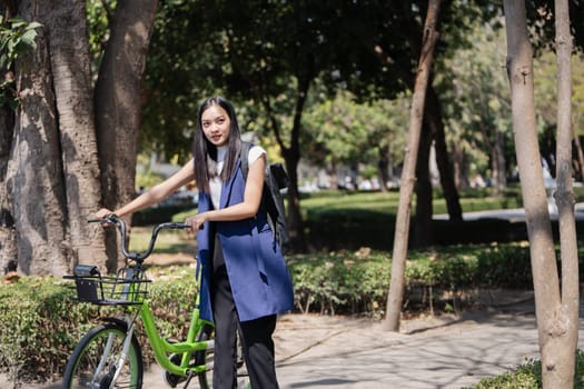 Professional Business woman with bike in the morning walking in the street to work. Eco friendly.