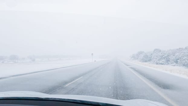 POV-Electric vehicle is captured deftly navigating the I-70 highway during a winter storm in Western Colorado.