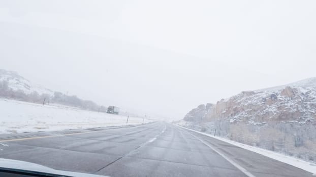 POV-Electric vehicle is captured deftly navigating the I-70 highway during a winter storm in Western Colorado.