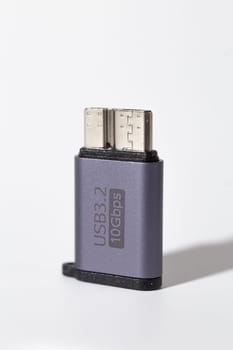 The image shows a dark grey USB 3.2 flash drive with a Type-C connector. The drive is isolated on a white background.