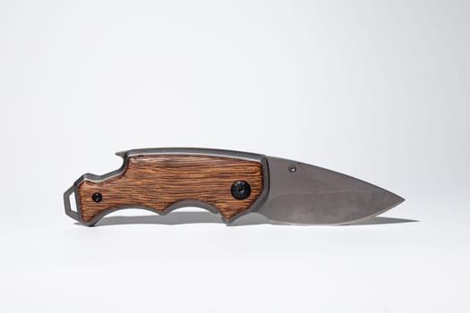 High-quality image featuring a stylish modern pocket knife with a durable wood handle, perfect for outdoor activities.