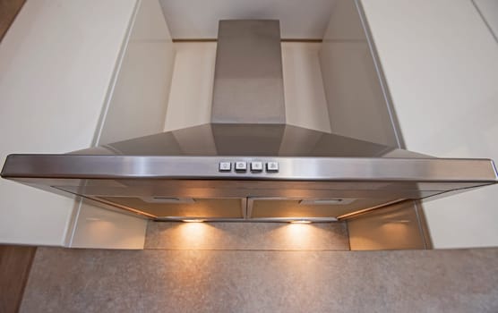 Closeup interior design decor detail showing modern kitchen in luxury apartment showroom with extractor exhaust fan