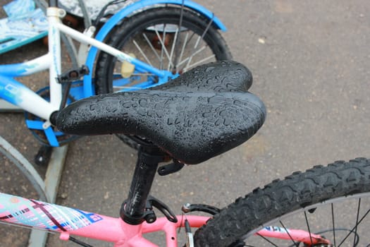 Photo the black seat of a child's bicycle. Sports and recreation for children. Spare parts.