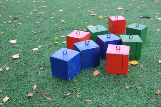 Photo colorful wooden cubes for outdoor play. Lawn covering. Games with children. rest.