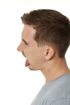 young man shows her toung, feels disgust on white background.