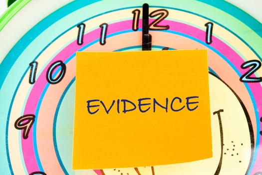 Word Evidence written written on an orange sticker