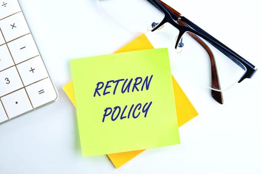 Return Policy written on a yellow sticker on a white background