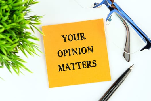 YOUR OPINION MATTERS phrase written on an orange sticker on a white background