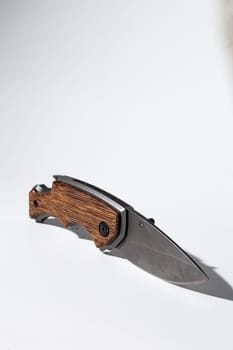 High-quality image featuring a stylish modern pocket knife with a durable wood handle, perfect for outdoor activities.