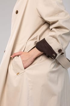 A sophisticated and timeless look for any occasion, this beige trench coat features a sleek and clean design with a hint of luxury.