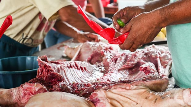 Preparation and dressing of a small suckling pig to cook over a wood fire