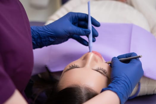 During a dental office visit, the dentist is examining the patients teeth