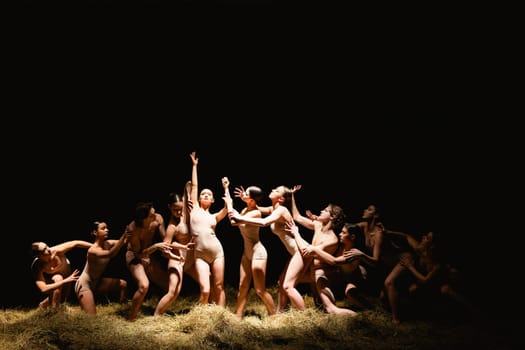 Group of modern ballet dancers. Contemporary art. Young flexible athletic men and women. Concept of dance grace, inspiration, creativity. Group of 11 models.