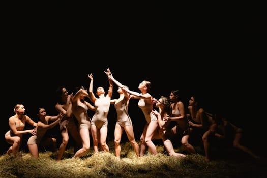 Group of modern ballet dancers. Contemporary art. Young flexible athletic men and women. Concept of dance grace, inspiration, creativity. Group of 11 models.