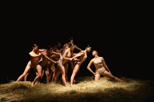 Group of modern ballet dancers. Contemporary art. Young flexible athletic men and women. Concept of dance grace, inspiration, creativity. Group of 11 models.