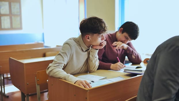 Schoolboys at a desk during class