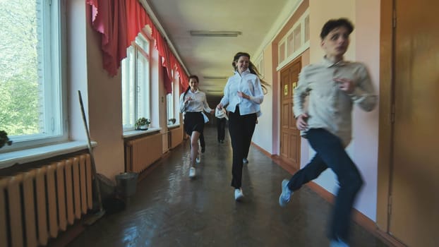 The students are running down the hallway of the school