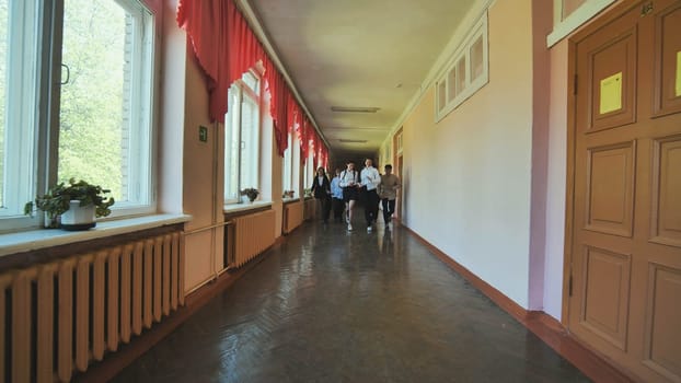 The students are running down the hallway of the school