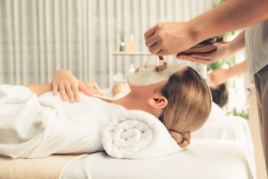 Serene ambiance of spa salon, couple indulges in rejuvenating with luxurious face cream massage with modern daylight. Facial skin treatment and beauty care concept. Quiescent