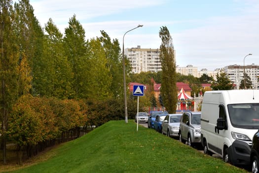 Moscow, Russia - 24 Sept 2023. Row of cars parked along sidewalk near the house