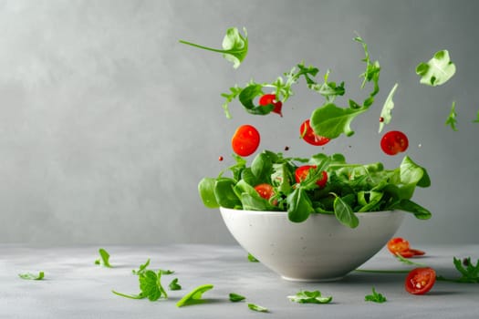 A white ceramic bowl is filled with fresh green lettuce leaves and juicy red tomatoes, creating a healthy salad.