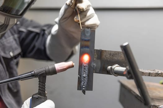 Welder man welding a metal, using the blowtorch, electric arc, or other means, and uniting them by pressing, heavy industrial concept