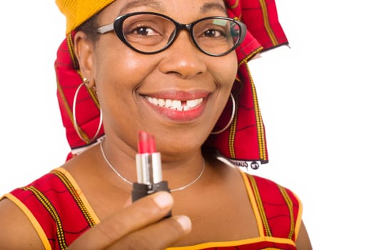 beauty, makeup and elderly concept in red african outfit - senior woman is holding a lipstick on white background.