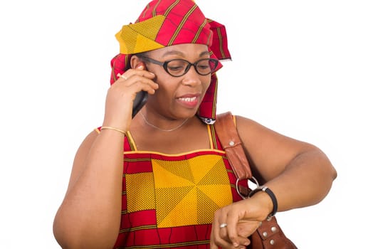 mature woman in loincloth standing on white background communicating on mobile phone smiling.