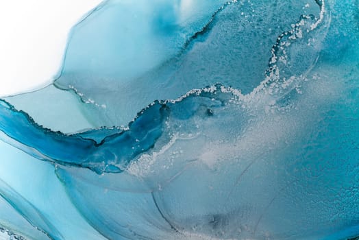 Beautiful background with smudges and stains alcohol ink. Abstract blue, red art with gold. Fragment of art with fluid texture resembles watercolor or aquarelle painting.