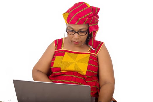 mature woman in loincloth on white background looking at laptop.