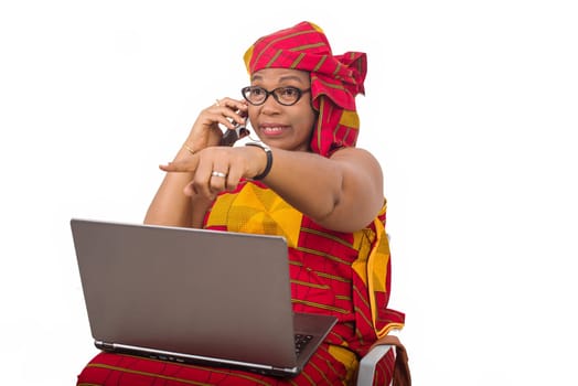 mature woman in loincloth on white background with computer on her thighs communicating on mobile phone